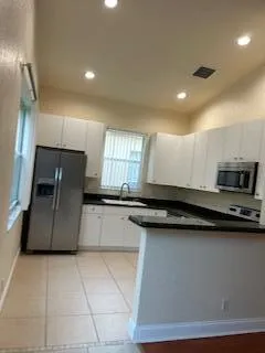 a kitchen with stainless steel appliances granite countertop a sink and a stove