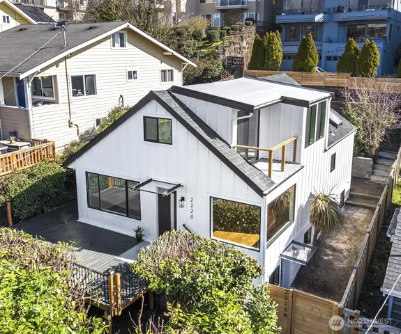 a aerial view of a house with yard and balcony