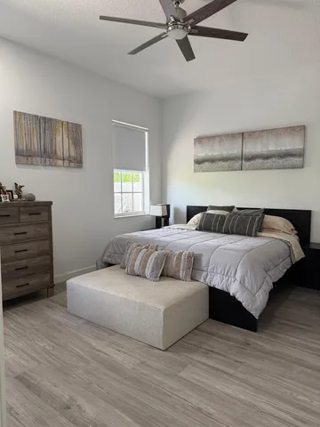 a bedroom with a bed and wooden floor