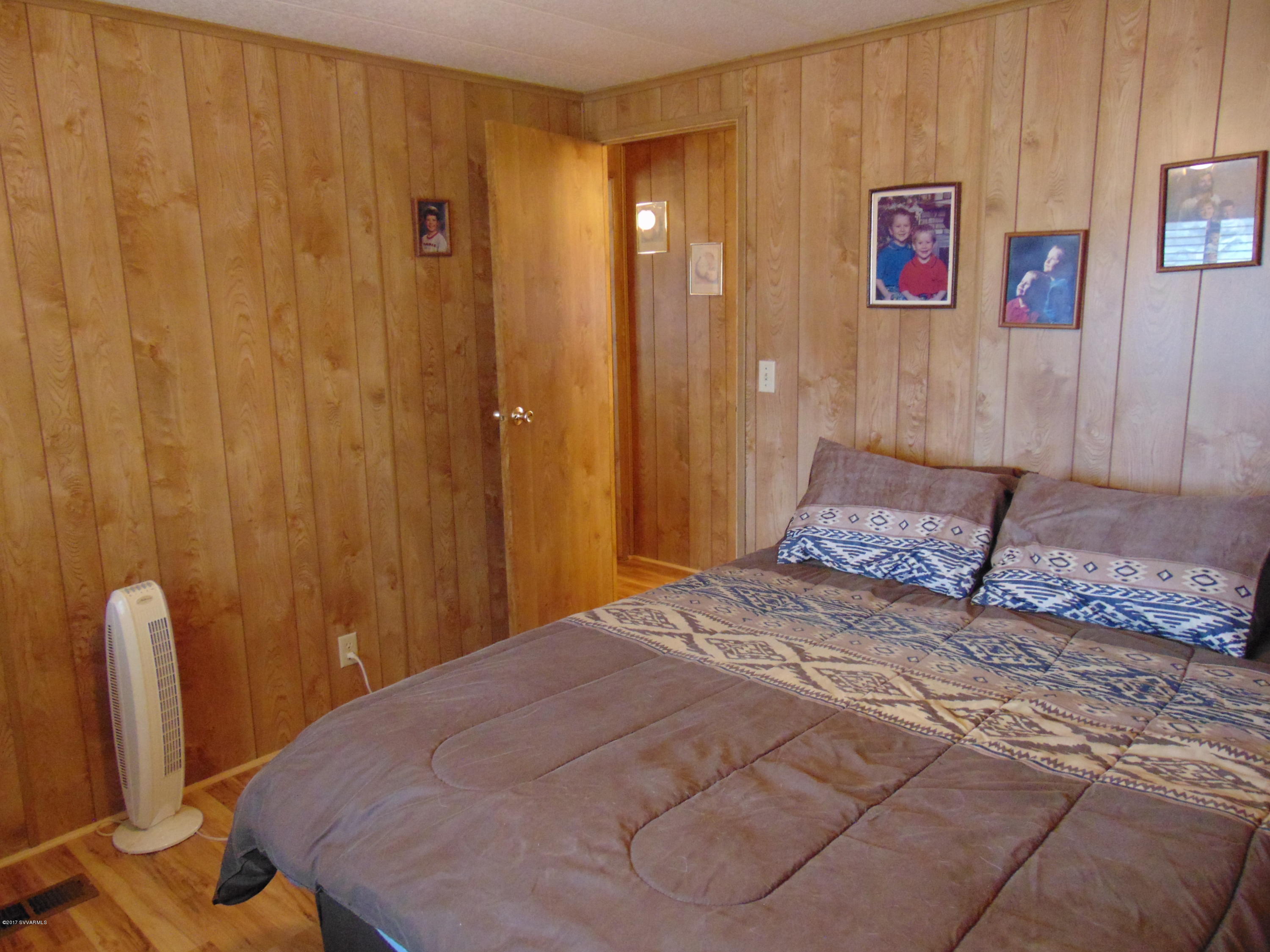 4715 Tagalong Trail Rimrock, AZ 86335 - Photo 18 of 30 a bedroom with a bed and a mirror