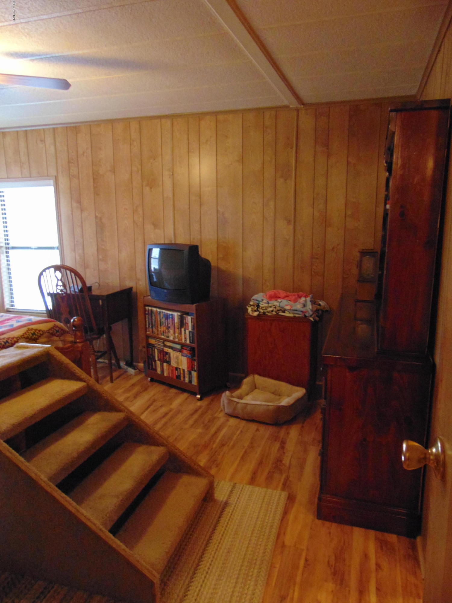 4715 Tagalong Trail Rimrock, AZ 86335 - Photo 22 of 30 a bedroom with a bed and a cabinet with the outer view