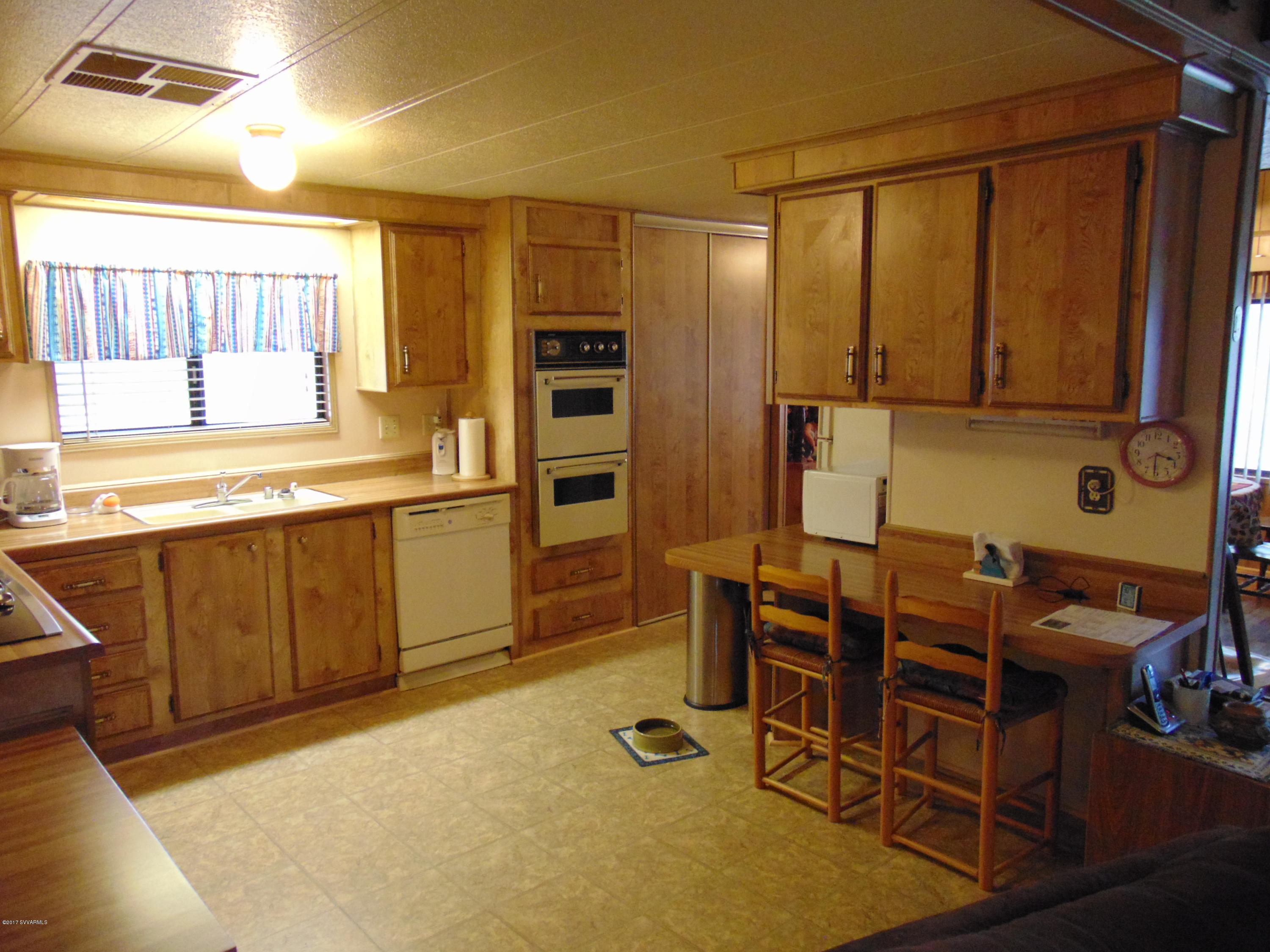 4715 Tagalong Trail Rimrock, AZ 86335 - Photo 9 of 30 a kitchen with table chairs sink and cabinets