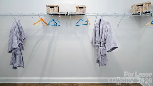 a living room with furniture a rug a lamp and a window