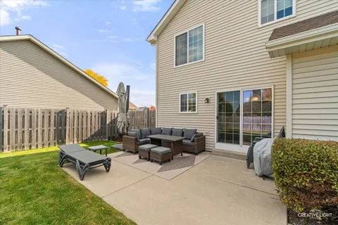 a swimming pool with outdoor seating and a garden