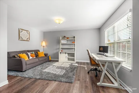 a workspace with furniture and a wooden floor