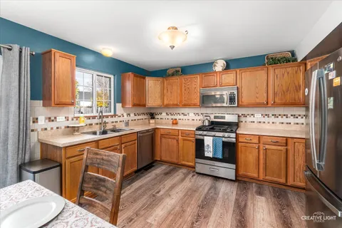a kitchen with a sink appliances and cabinets