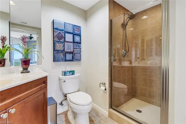 a bathroom with a shower a sink a toilet and a mirror
