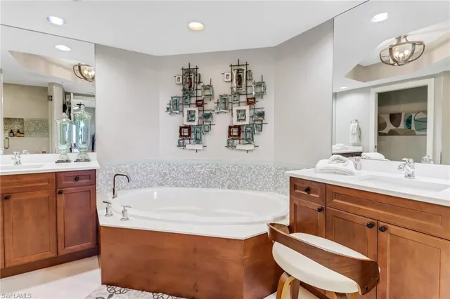 a bathroom with a bathtub sink and mirror