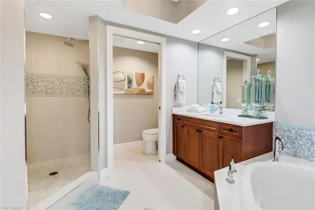 a bathroom with a double vanity sink mirror and shower