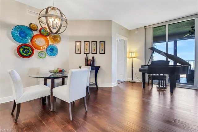 a view of a dining room with furniture and a floor to ceiling window