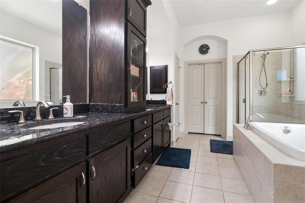 6715 Castillo Street Irving, TX 75039 - Photo 14 of 24 a spacious bathroom with a granite countertop sink mirror and bathtub