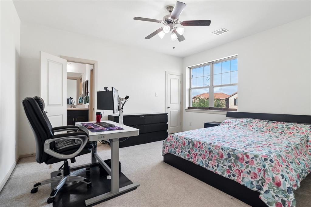 6715 Castillo Street Irving, TX 75039 - Photo 18 of 24 a bedroom with a bed a desk and chair