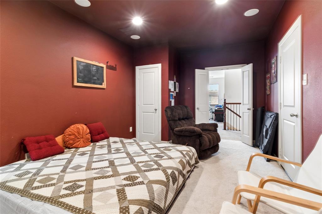 6715 Castillo Street Irving, TX 75039 - Photo 21 of 24 a bedroom with a bed and a couch