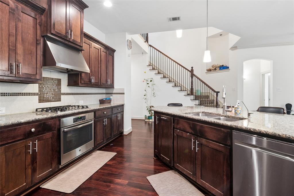 6715 Castillo Street Irving, TX 75039 - Photo 7 of 24 a kitchen with stainless steel appliances granite countertop a sink a stove and cabinets