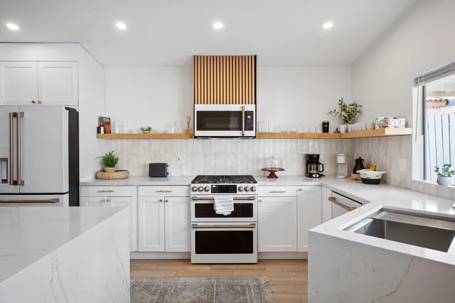 a kitchen with cabinets stainless steel appliances and a sink