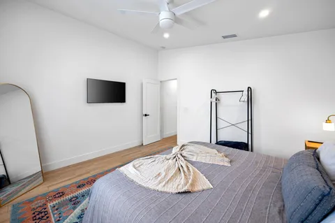 a bedroom with a bed and a flat screen tv