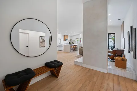 a living room with furniture and a mirror