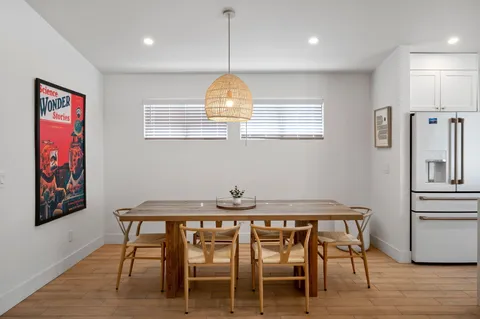 a view of a dining room with furniture wooden floor and chandelier