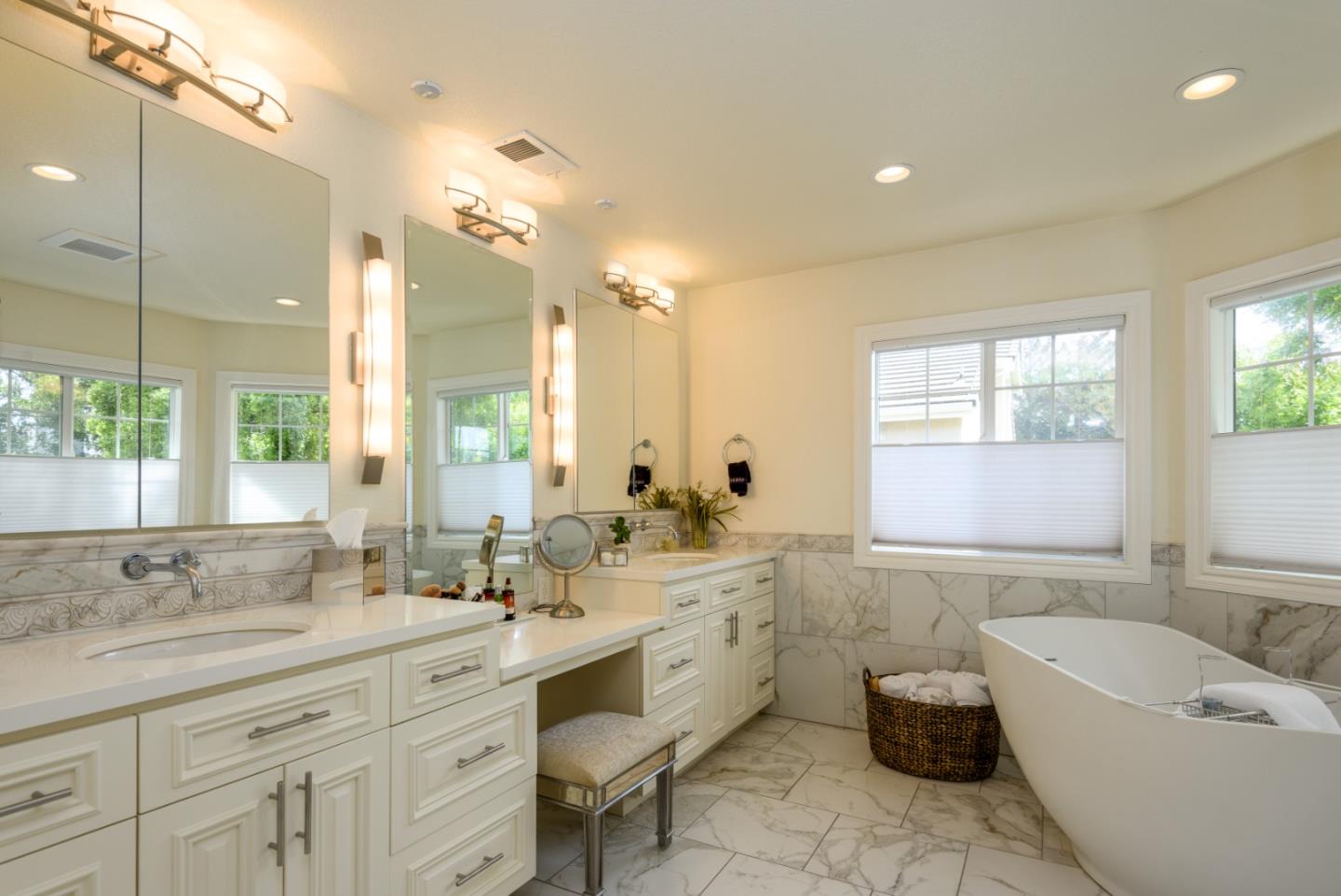 376 Eagle Trace Drive Half Moon Bay, CA 94019 - Photo 18 of 43 a bathroom with a double vanity sink bathtub large mirror and next to a window