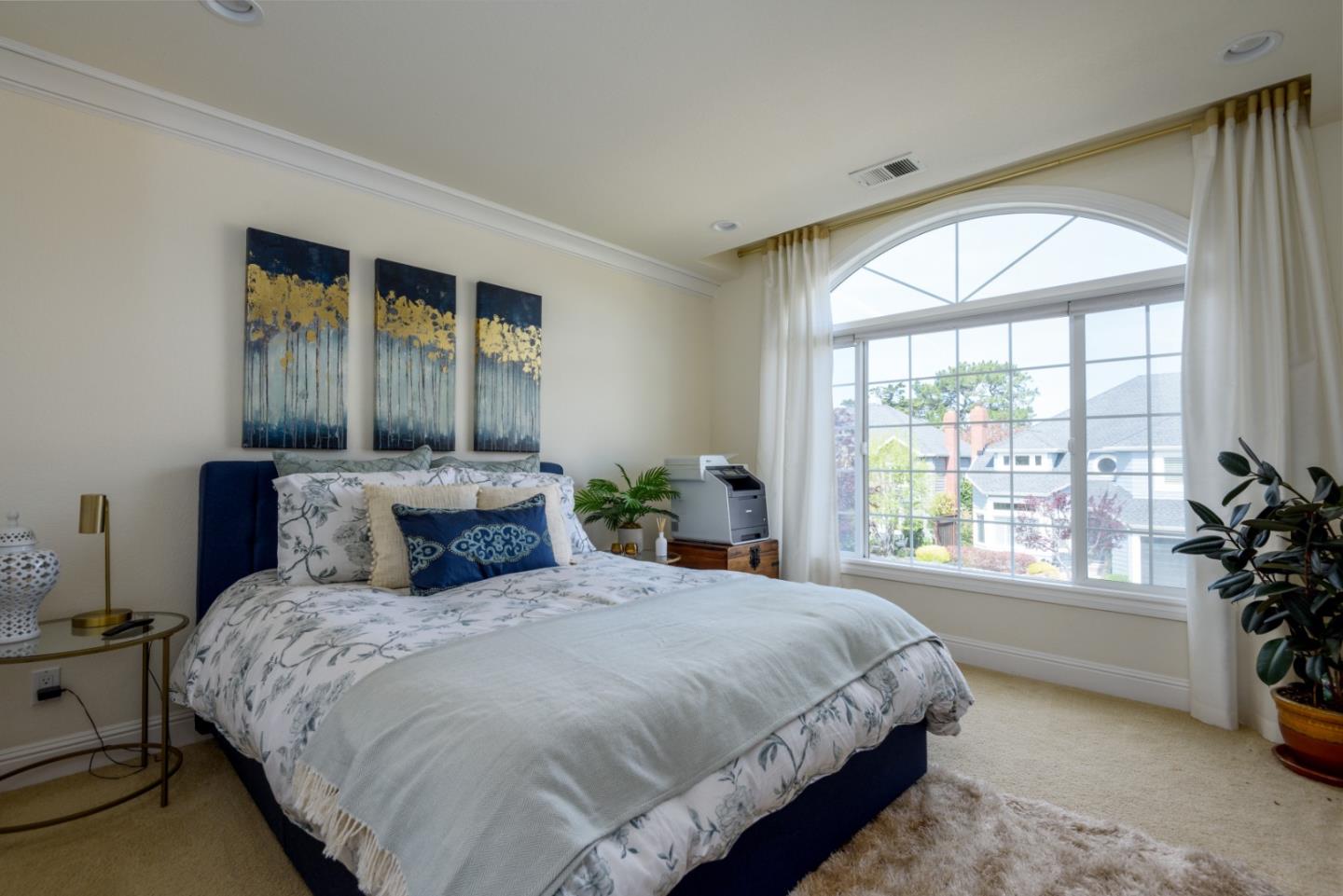 376 Eagle Trace Drive Half Moon Bay, CA 94019 - Photo 21 of 43 a bedroom with a large bed and a potted plant