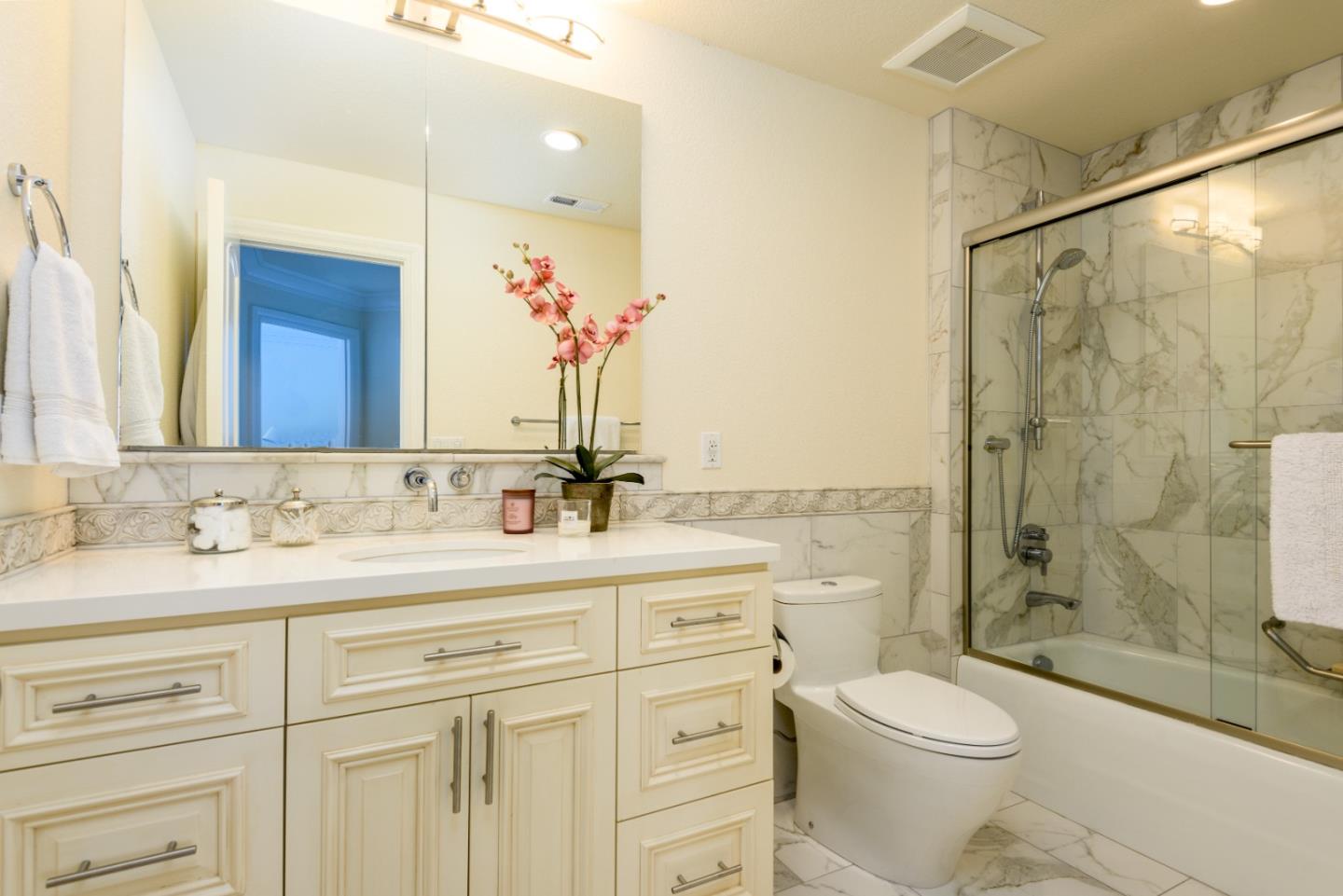 376 Eagle Trace Drive Half Moon Bay, CA 94019 - Photo 24 of 43 a bathroom with a double vanity sink toilet mirror and shower
