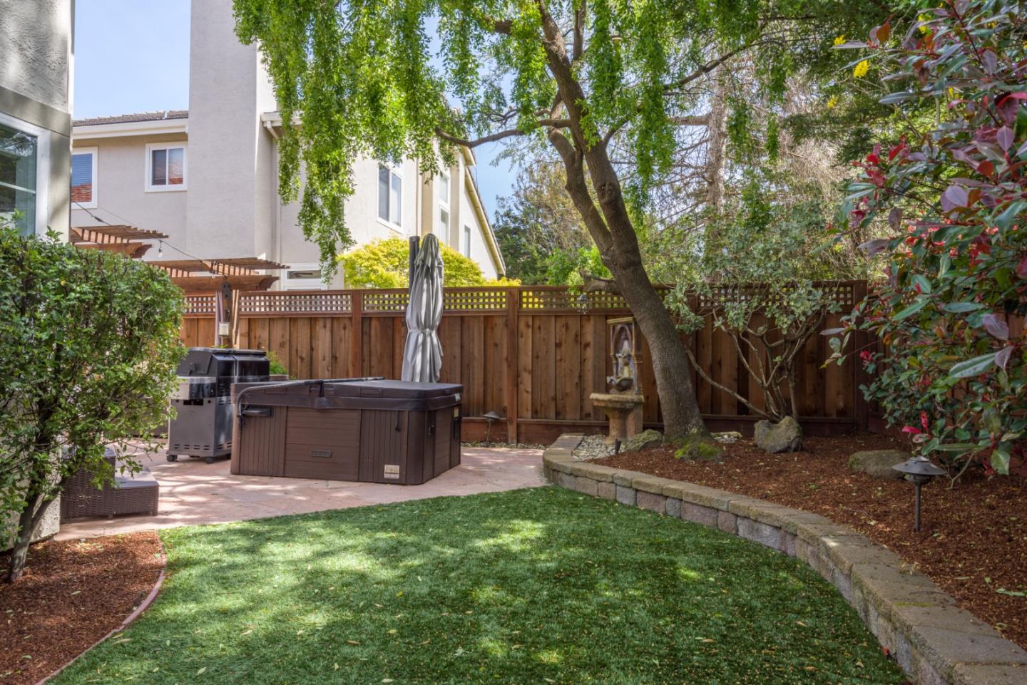 376 Eagle Trace Drive Half Moon Bay, CA 94019 - Photo 30 of 43 a view of backyard with table and chairs and a large tree