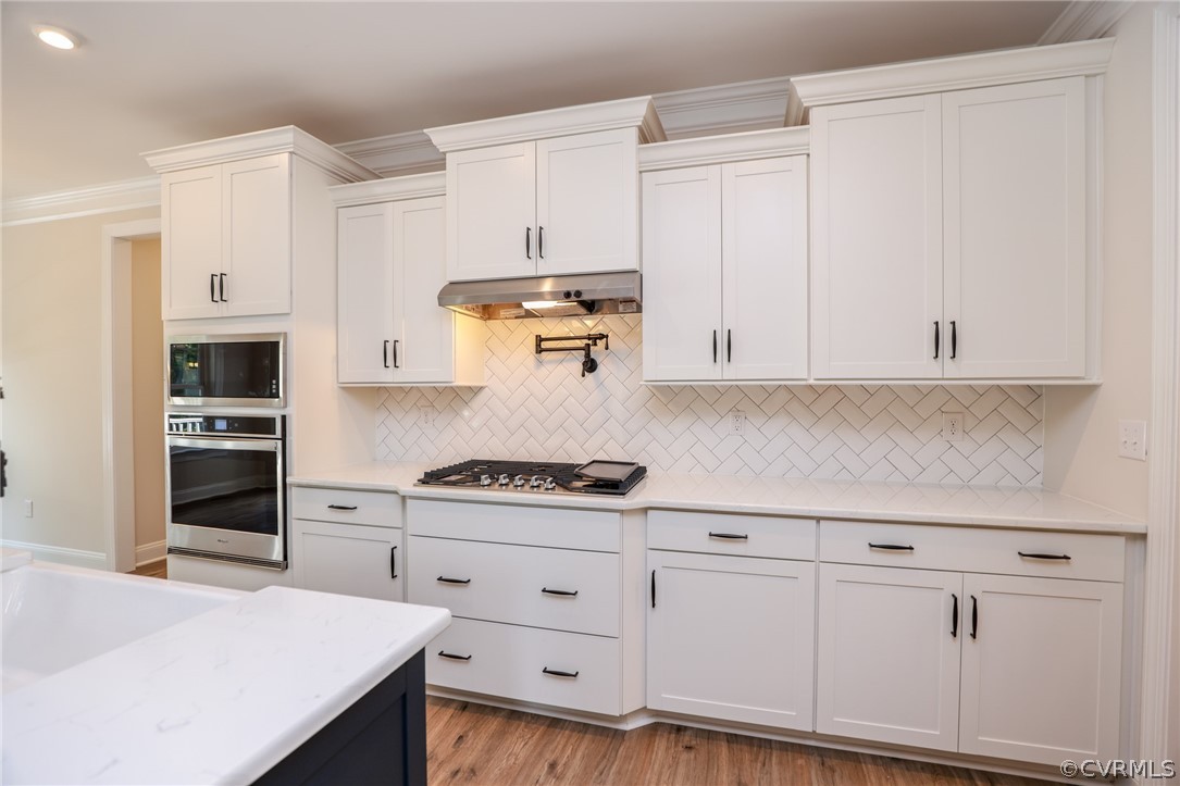 4353 Landfall Drive Williamsburg, VA 23185 - Photo 4 of 13 a kitchen with white cabinets and white appliances