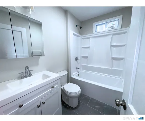 a bathroom with a sink a toilet and a bathtub