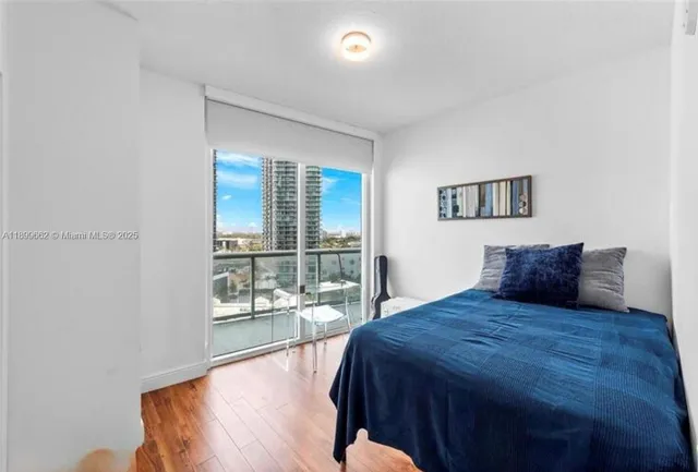 a bedroom with a large bed and a large window