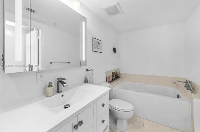 a bathroom with a sink a toilet and a bathtub