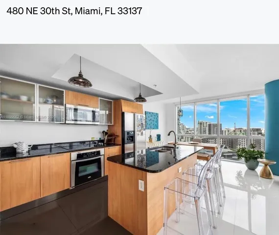 a kitchen with stainless steel appliances granite countertop a stove and a refrigerator