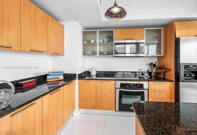 a kitchen with stainless steel appliances granite countertop a stove and a sink