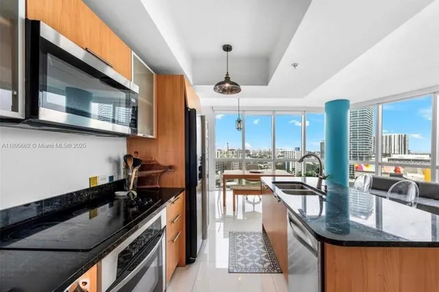 a kitchen with stainless steel appliances granite countertop a stove and a sink