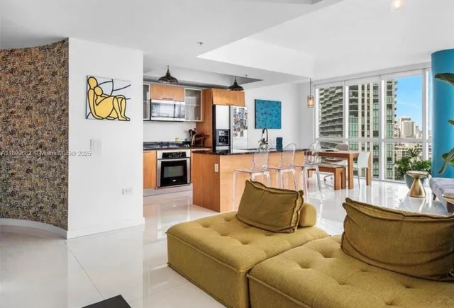 a living room with furniture and large windows