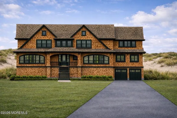 a front view of house with yard and garage