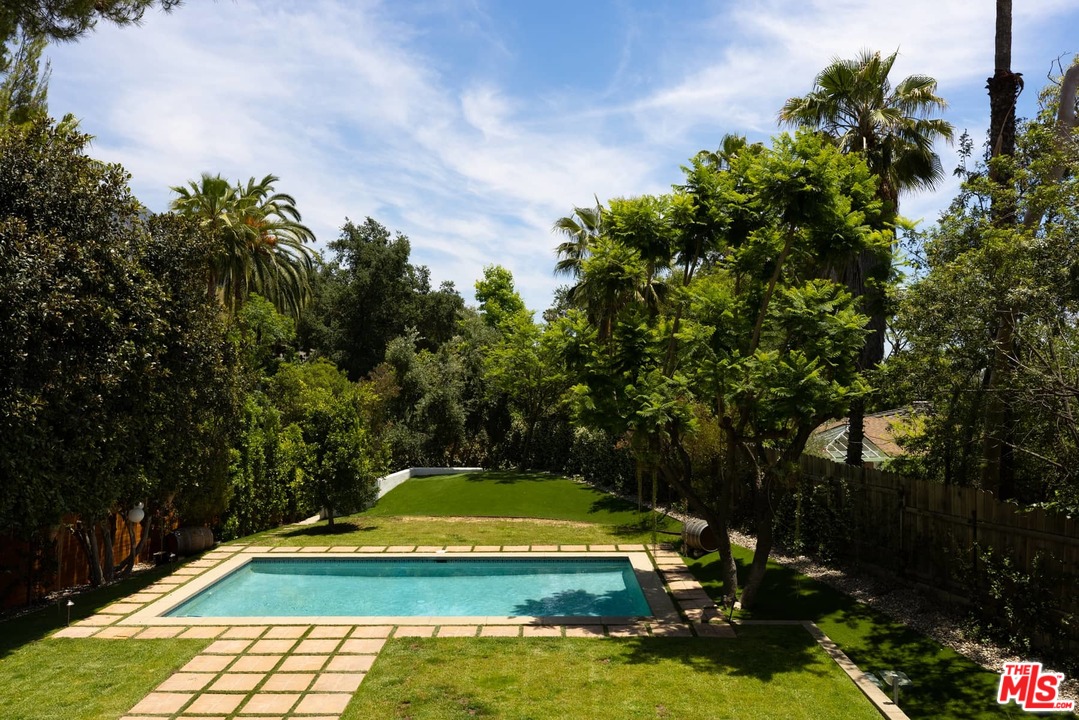 1435 Crest Drive Altadena, CA 91001 - Photo 39 of 54 a view of a swimming pool with lawn chairs under an umbrella