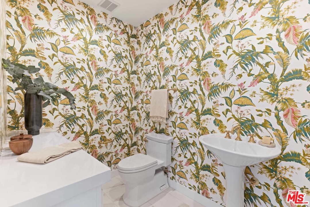 1435 Crest Drive Altadena, CA 91001 - Photo 47 of 54 a white toilet sitting next to a shower curtain