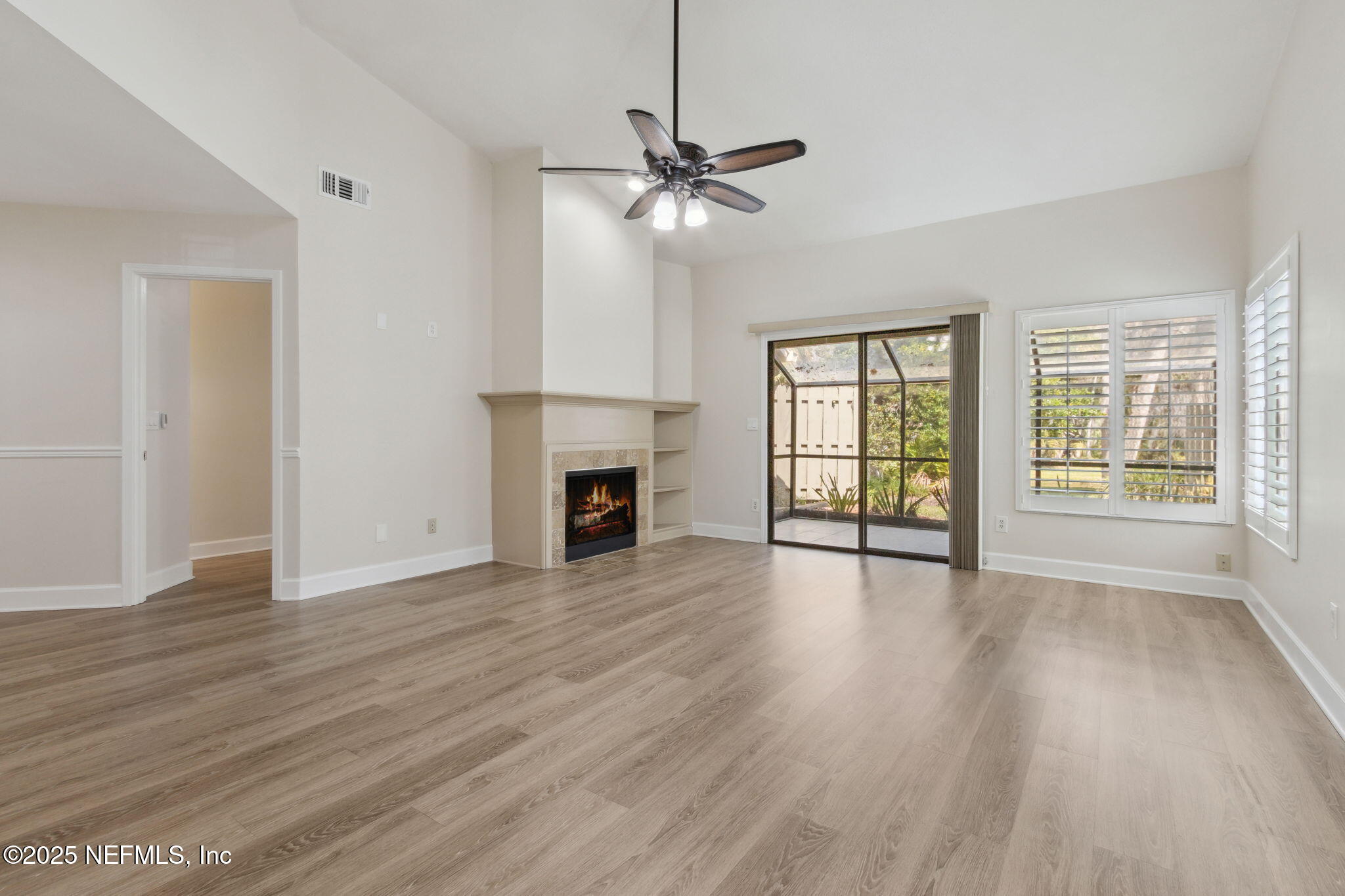 14 Turtleback Trail Ponte Vedra Beach, FL 32082 - Photo 5 of 63 an empty room with wooden floor fan and windows