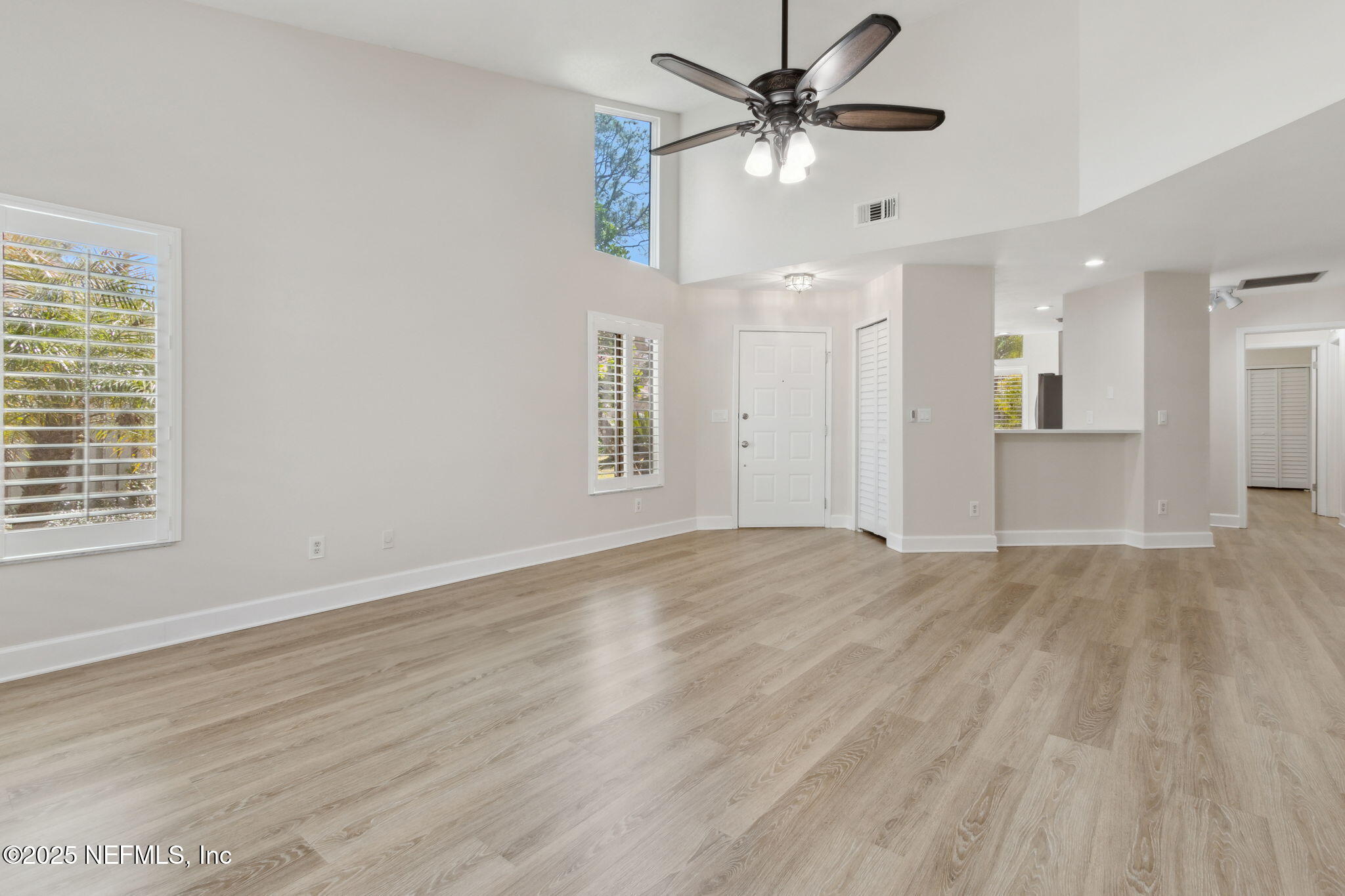 14 Turtleback Trail Ponte Vedra Beach, FL 32082 - Photo 63 of 63 an empty room with wooden floor ceiling fan and windows
