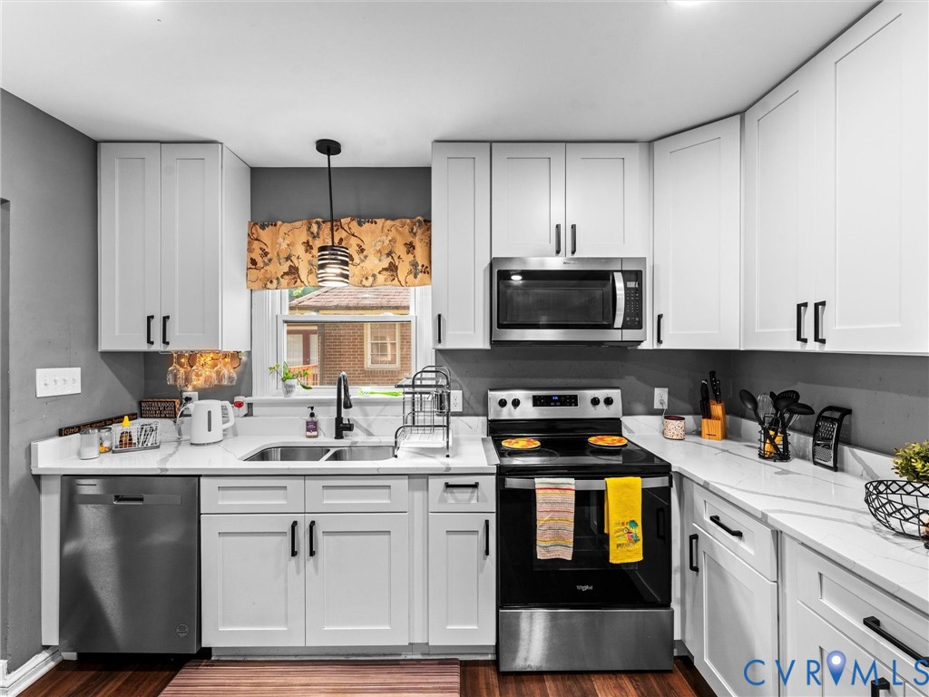 Kitchen featuring white shaker-style cabinetry wit