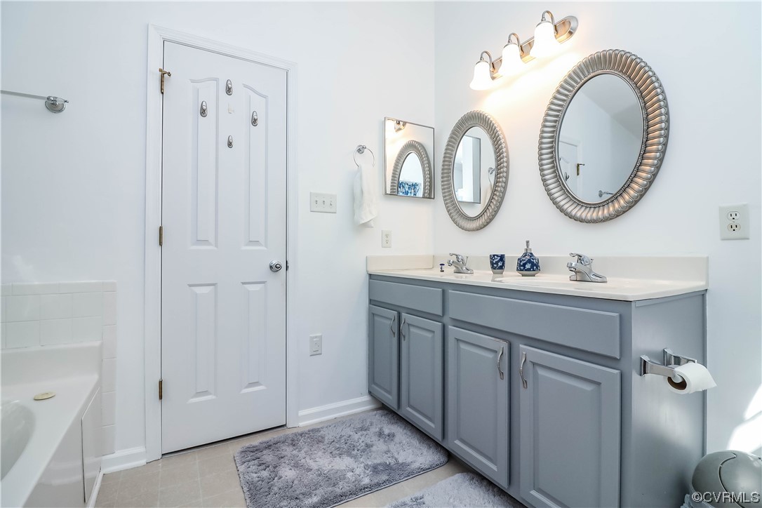 9219 Alcove Grove Road Chesterfield, VA 23832 - Photo 24 of 41 a bathroom with a granite countertop double vanity sink and a mirror