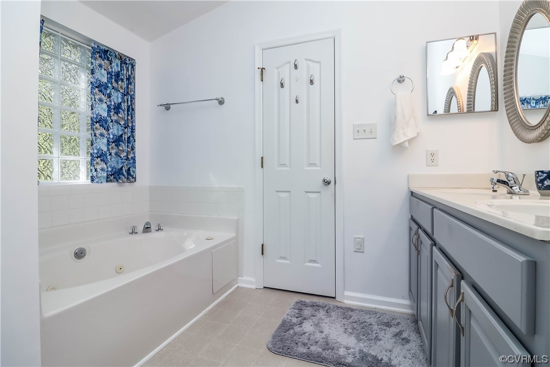 9219 Alcove Grove Road Chesterfield, VA 23832 - Photo 26 of 41 a bathroom with a tub sink and mirror