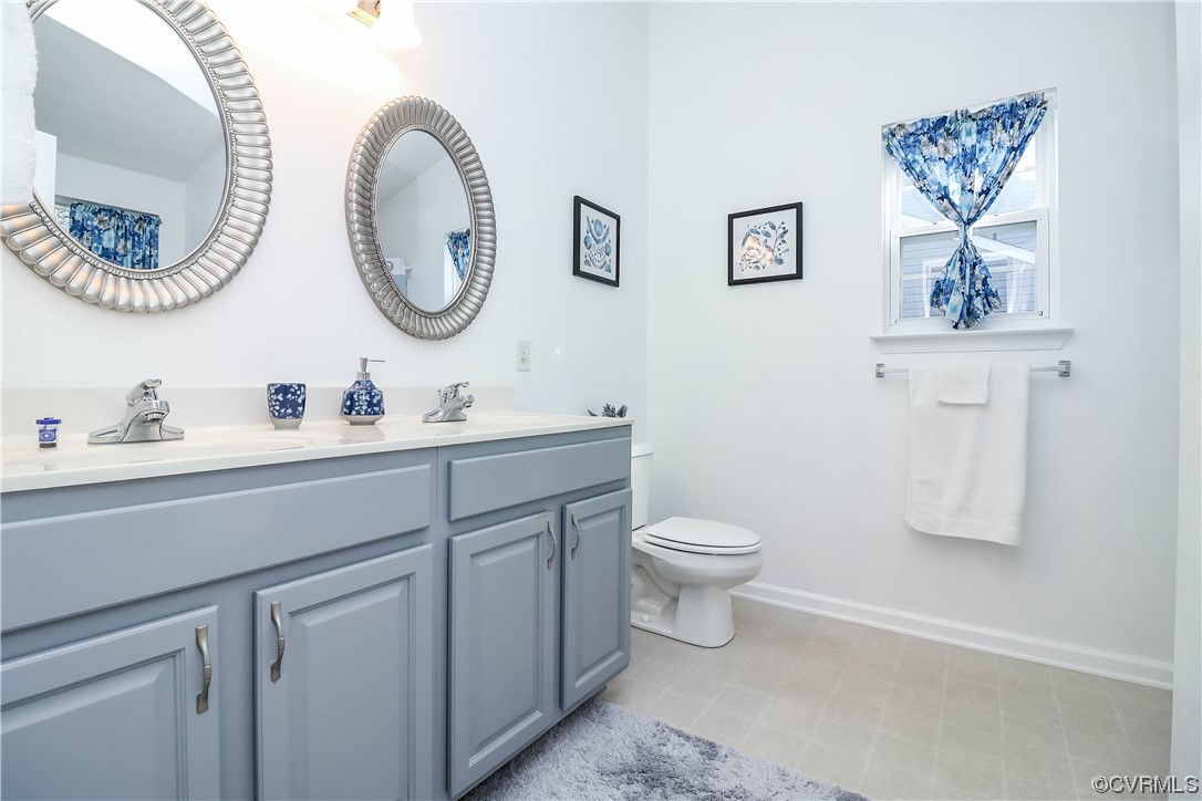 9219 Alcove Grove Road Chesterfield, VA 23832 - Photo 28 of 41 a bathroom with a toilet a sink and a mirror