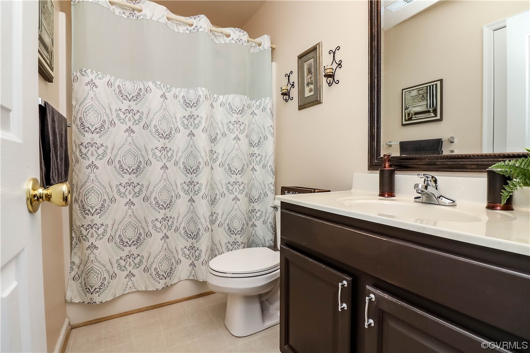 9219 Alcove Grove Road Chesterfield, VA 23832 - Photo 30 of 41 a bathroom with a granite countertop toilet sink and mirror