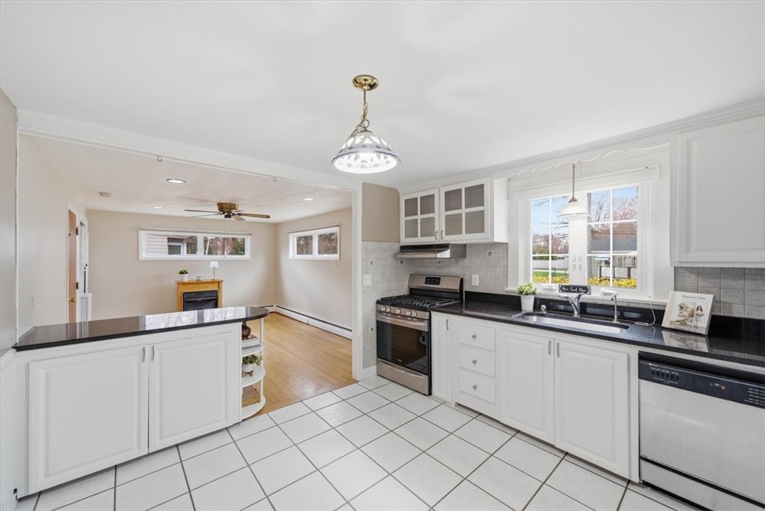 28 Glenbrook Road Warwick, RI 02889 - Photo 11 of 43 The renovated kitchen features “Black Pearl” granite countertops, ceramic tile flooring, a storage peninsula, and gas cooking—perfect for everyday living and entertaining.