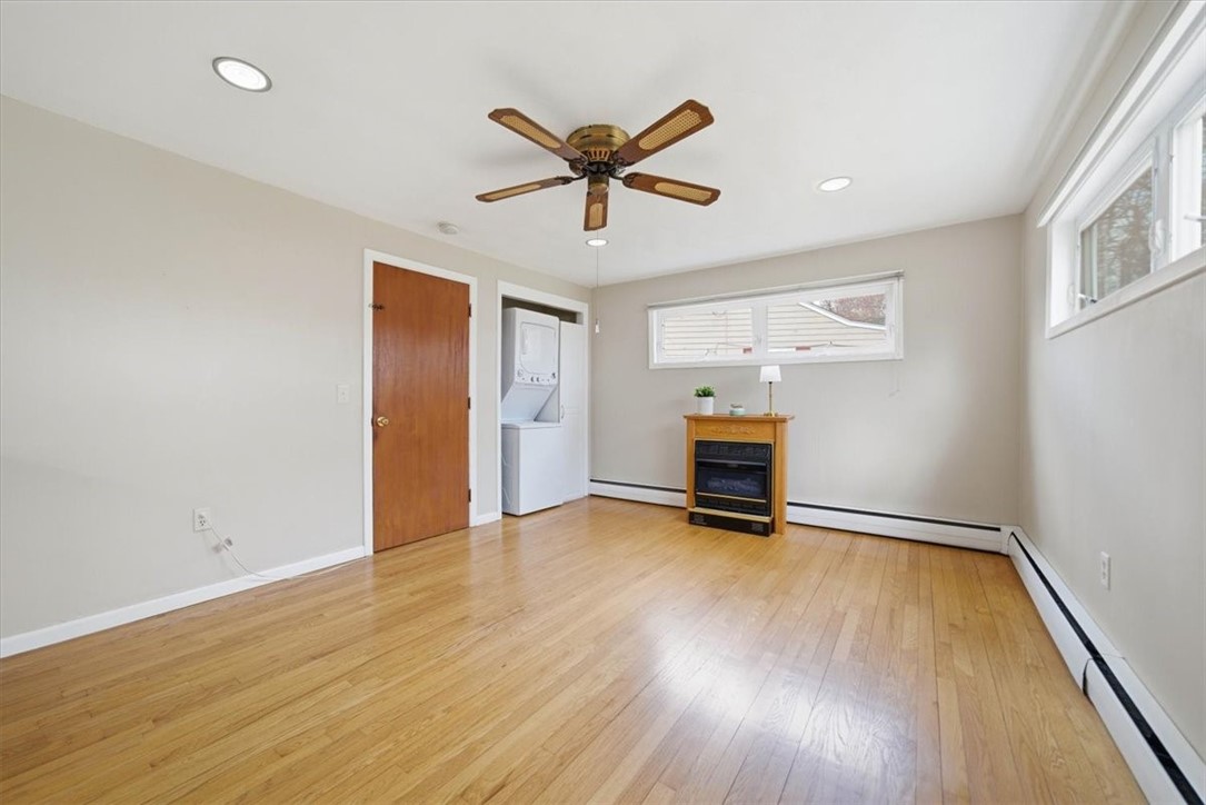 28 Glenbrook Road Warwick, RI 02889 - Photo 14 of 43 Just beyond, the dining area offers a cozy gas fireplace and direct access to the backyard patio—perfect for entertaining or relaxing evenings outdoors. Part of the garage was used for this renovation.