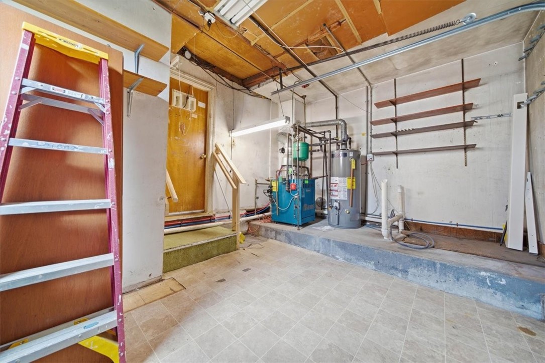 28 Glenbrook Road Warwick, RI 02889 - Photo 27 of 43 A portion of the garage has been repurposed into a dining room, while the remaining shortened garage accommodates utilities and provides versatile storage for motorcycles, bikes, and lawn equipment.