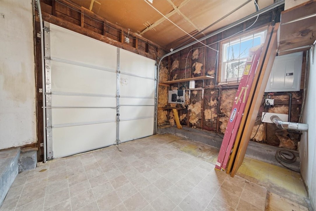 28 Glenbrook Road Warwick, RI 02889 - Photo 28 of 43 A portion of the garage has been repurposed into a dining room, while the remaining shortened garage accommodates utilities and provides versatile storage for motorcycles, bikes, and lawn equipment