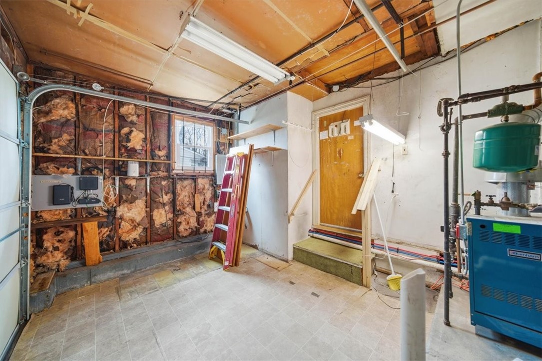 28 Glenbrook Road Warwick, RI 02889 - Photo 29 of 43 A portion of the garage has been repurposed into a dining room, while the remaining shortened garage accommodates utilities and provides versatile storage for motorcycles, bikes, and lawn equipment