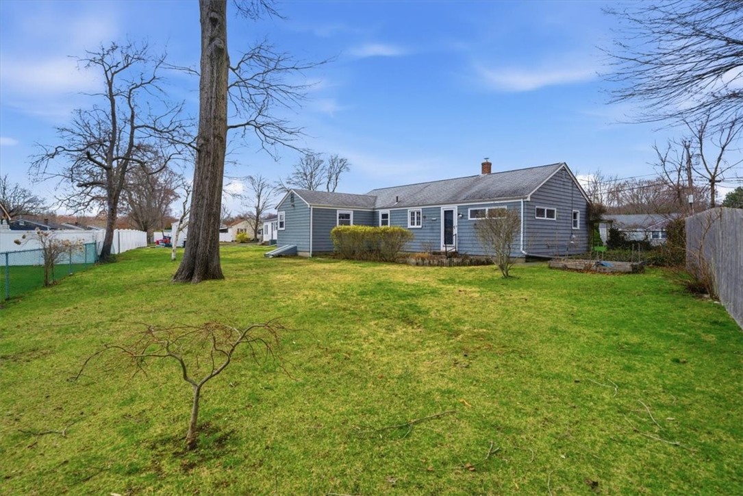 28 Glenbrook Road Warwick, RI 02889 - Photo 33 of 43 Set on a mostly fenced lot, you'll enjoy a private backyard complete with a patio and charming koi pond—perfectly complemented by a premium Zoysia lawn that is lush, barefoot-friendly, durable, and low maintenance.